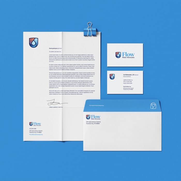 Letterhead, business cards, and envelope for "Flow Water Advocates" on a blue background. Clean, professional design with a water droplet logo.