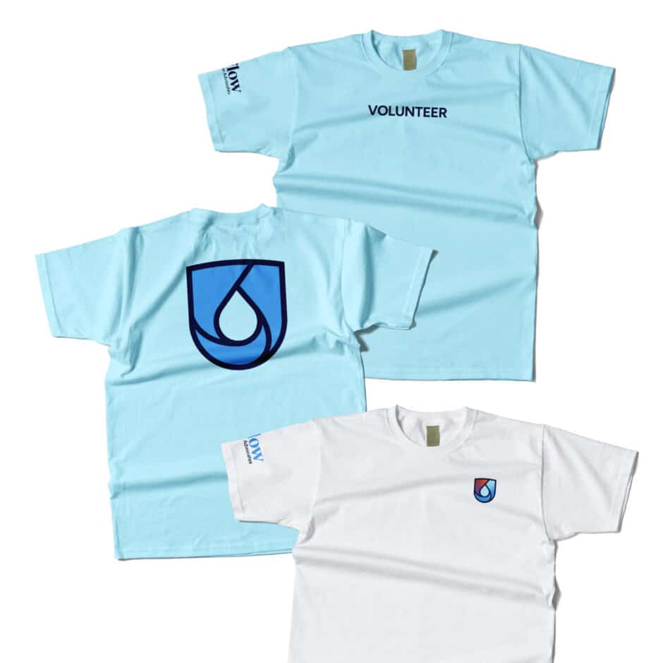 Light blue and white T-shirts are shown. The blue shirts read "VOLUNTEER" on the front and have a blue droplet logo on the back. The white shirt features the same logo on the front.