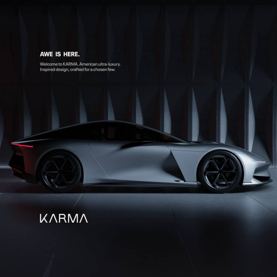Sleek, dark-toned luxury car in profile with sharp lines and futuristic design, set against a geometric wall. Text reads “Awe is here. Karma.”