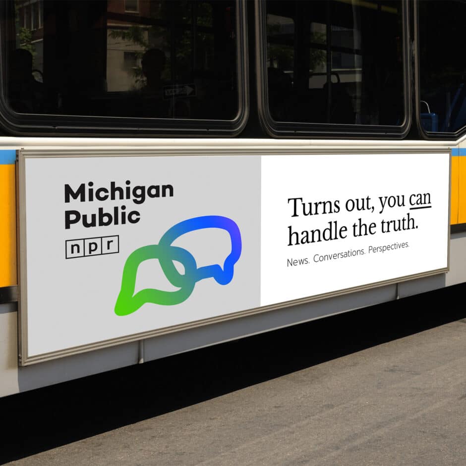 Bus advertising poster for Michigan Public Radio with interlinked green and blue speech bubbles. Text reads, "Turns out, you can handle the truth."