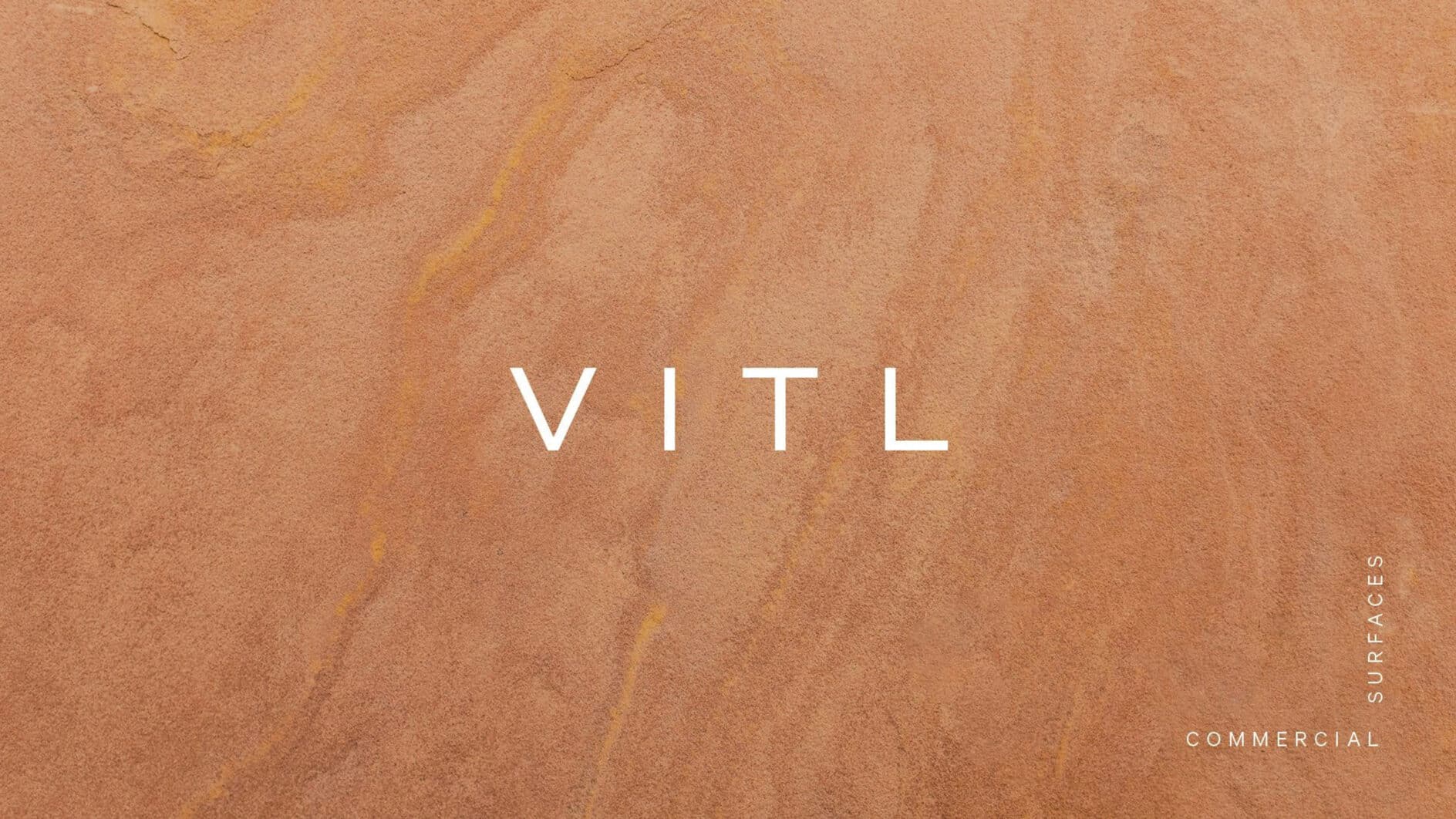 A textured light brown, sandstone backdrop with subtle variations in tone. "VITL" is centered in white text. "Commercial Surfaces" is vertically aligned on the right.