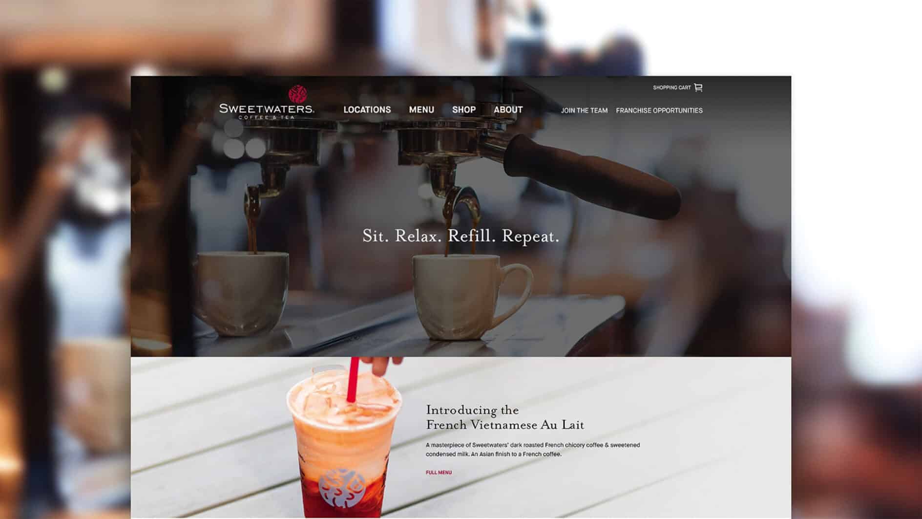 Coffee shop interior with two mugs under an espresso machine, captioned 'Sit. Relax. Refill. Repeat.' Below, a vibrant iced coffee with a straw promotes a French Vietnamese Au Lait introduction. Cozy, inviting atmosphere.