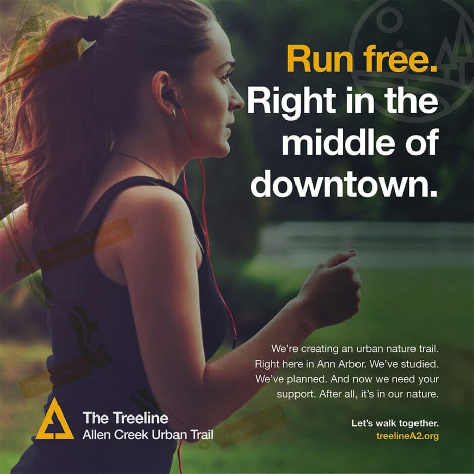 A woman jogs with earbuds in a lush, green park setting, conveying activity and freedom. Text reads "Run free. Right in the middle of downtown." Details about The Treeline trail project in Ann Arbor are included.