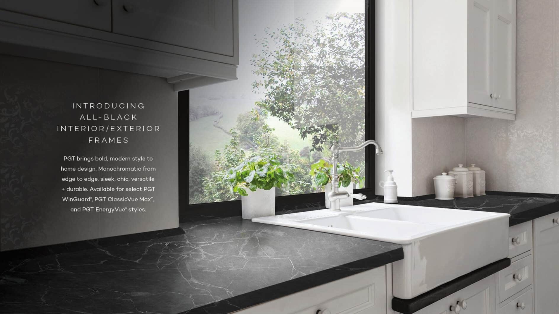 Modern kitchen with sleek black countertops, white cabinets, and a farmhouse sink. A large window with a black frame overlooks lush greenery. Text describes all-black interior/exterior frames.