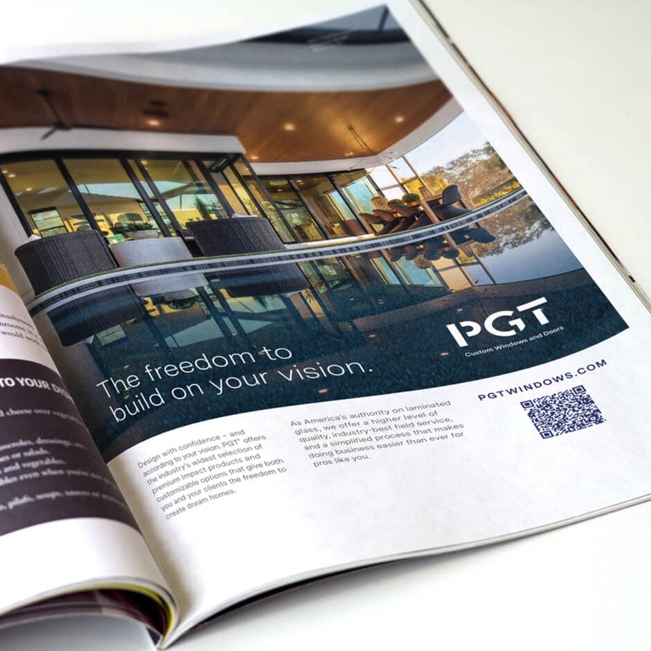 Magazine ad showing a modern house with large glass windows reflecting a pool. Text reads "The freedom to build on your vision." PGT logo visible.