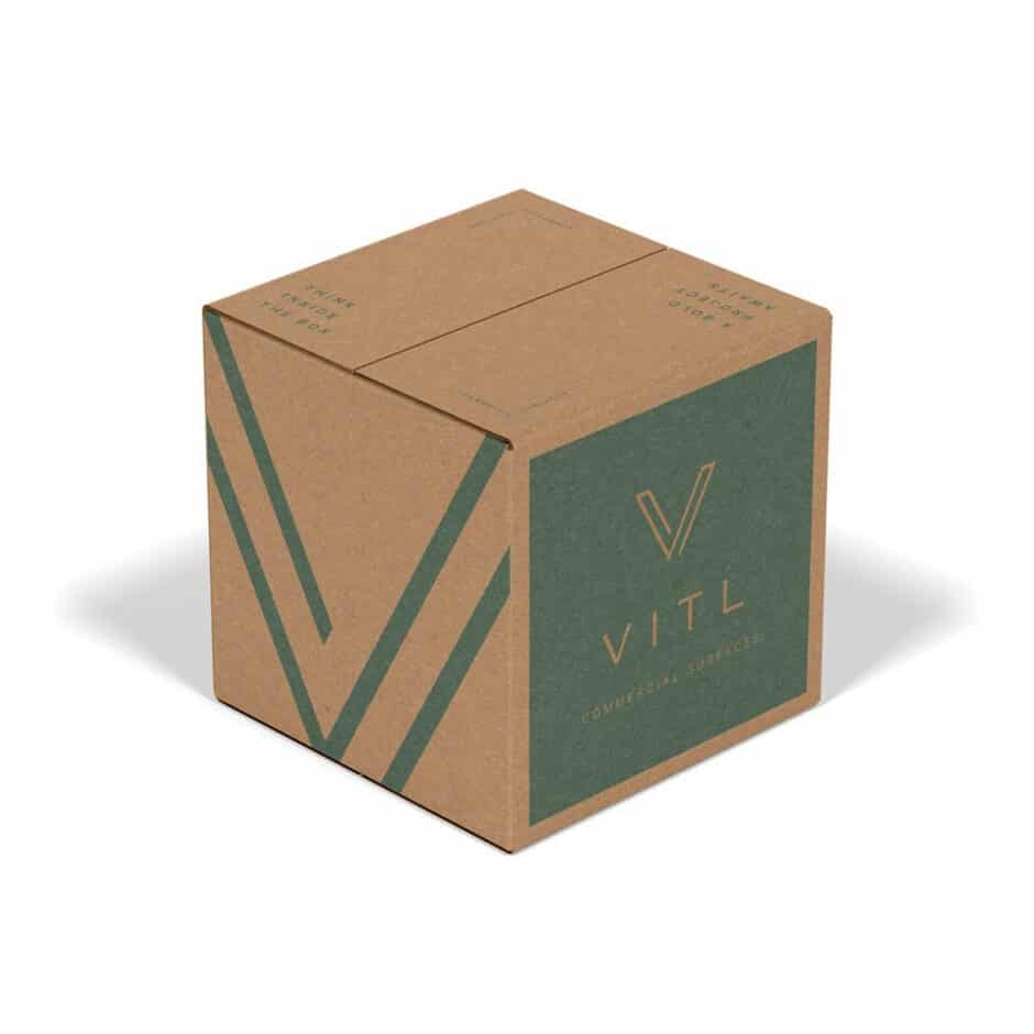 A brown cardboard box with green accents and the text "VITL" on one side, features minimalist design elements, conveying a modern and eco-friendly tone.
