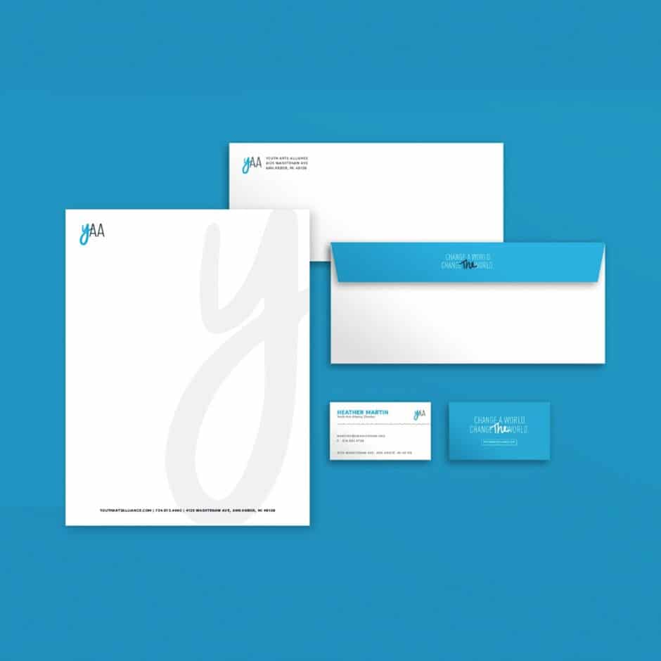 A coordinated blue and white stationery set with a modern design features a letterhead, envelopes, and business cards, creating a clean, professional look.