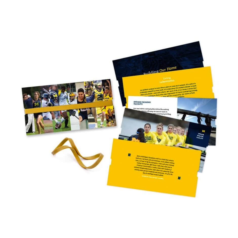 A set of athletic-themed brochures with University of Michigan branding. Features dynamic images of sports and athletes, accented by bold yellow and blue text.