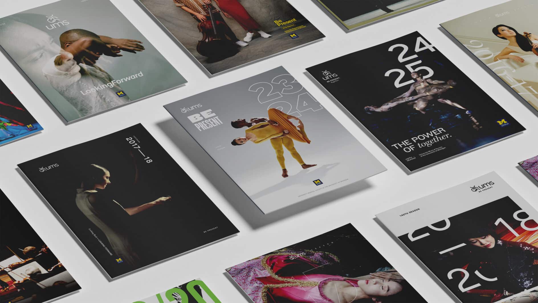 An array of colorful posters is laid out, featuring diverse dancers in dynamic poses. The designs range from minimalist to vibrant, conveying artistic energy.