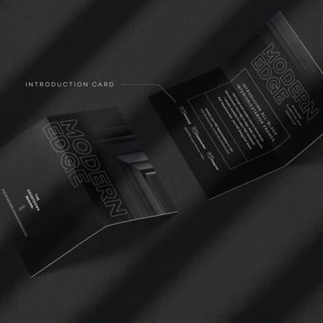 A sleek black introduction card with the text "Modern Edge" is shown both closed and slightly open on a textured dark surface, conveying elegance and sophistication.