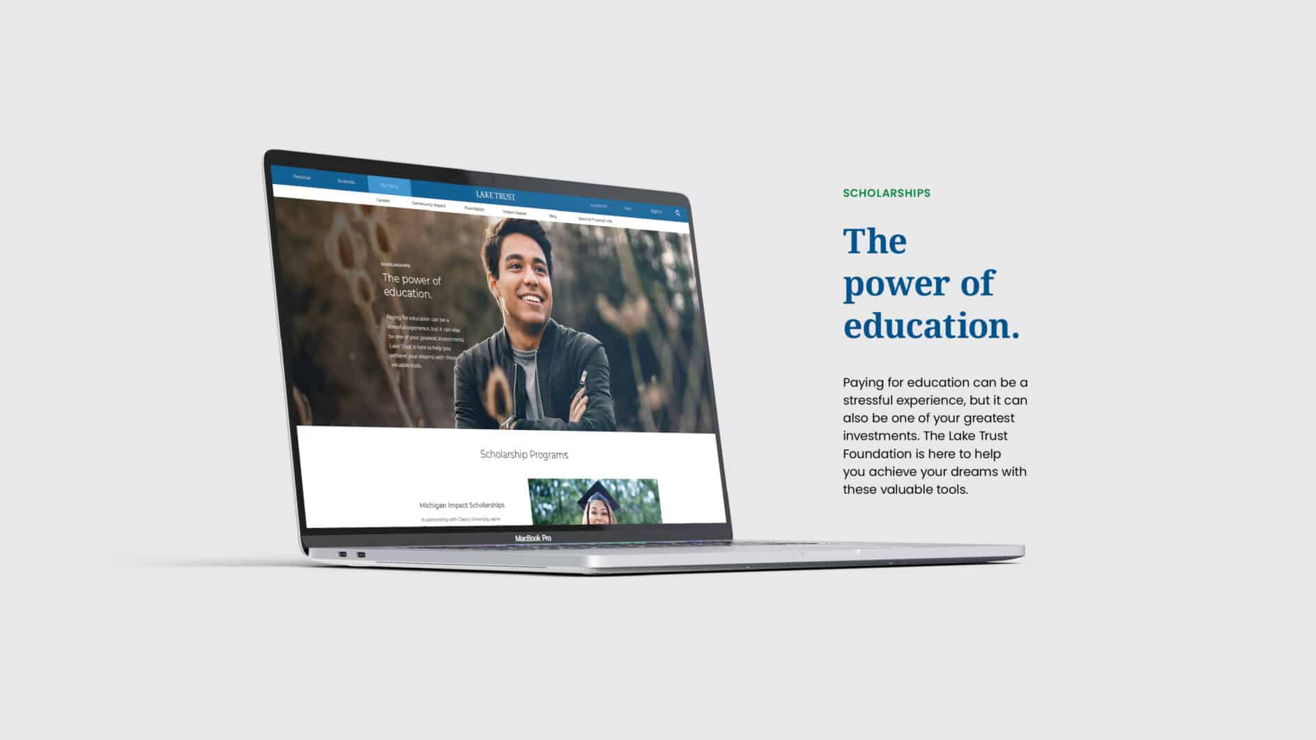 Laptop displaying a smiling person on a website about scholarships, next to text reading, "The power of education," implying optimism and support.
