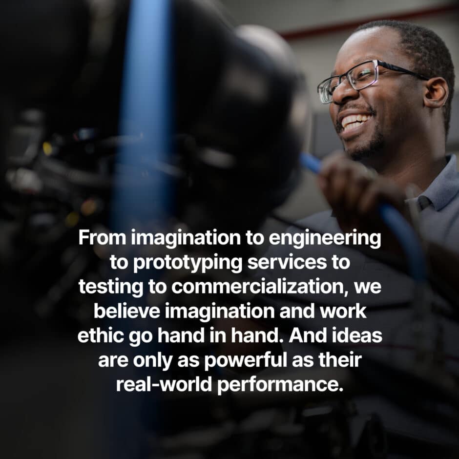 A smiling man in a workshop handles machinery with focus. The text beside him emphasizes the journey from imagination to commercialization and performance.