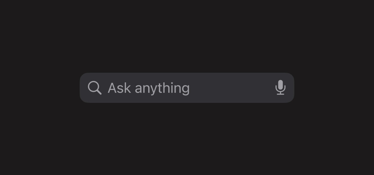 Search bar against a dark background with the text "Ask anything." It features a magnifying glass icon on the left and a microphone icon on the right.
