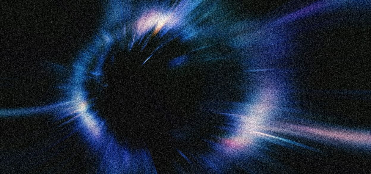 Abstract image depicting a black void at the center, surrounded by vibrant blue and purple light streaks, conveying a sense of motion and energy.