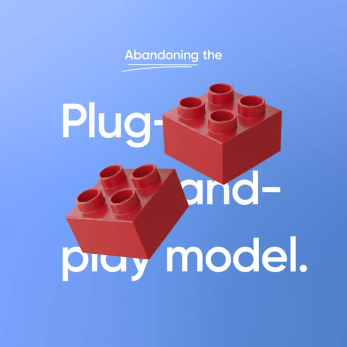 Two red toy blocks float on a blue background with white text saying "Abandoning the Plug-and-play model." The tone is modern and innovative.