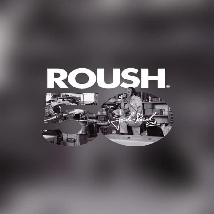 Text "ROUSH 50" overlays a workshop scene with a man, tools, and machinery. The tone is nostalgic and industrial, celebrating a milestone.