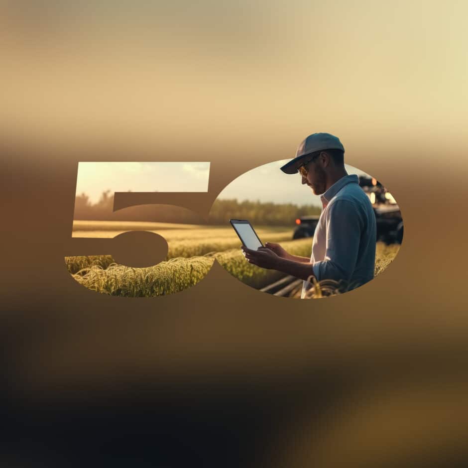 A farmer using a tablet stands in a wheat field at sunset. The scene is creatively framed within the number "50," emphasizing modern agriculture.