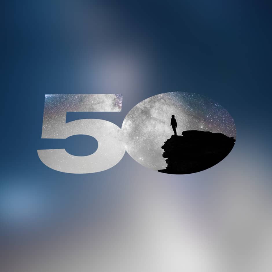 The number "50" overlays a cosmic background with a silhouette of a person standing on a cliff, conveying exploration and awe. The scene is set against a soft, blurred night sky.