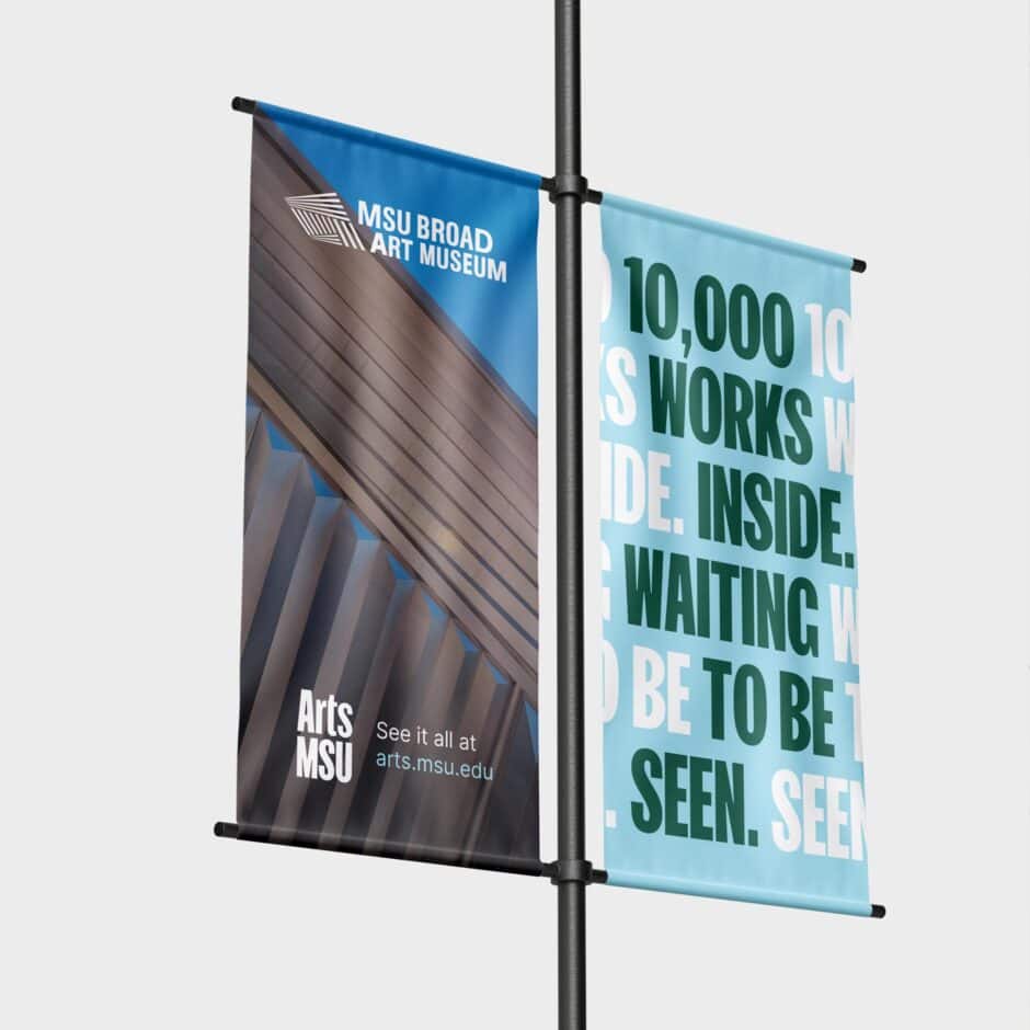 Street pole banners for MSU Broad Art Museum feature architectural design and text reading "10,000 Works Inside Waiting to Be Seen."