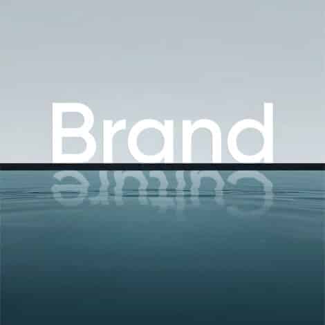 Minimalist seascape with the word “Brand” in large white letters above the horizon, mirrored in calm blue water under a pale sky.