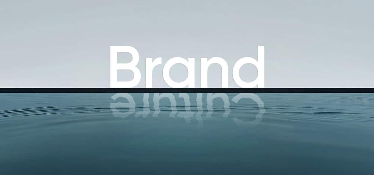 Minimalist seascape with the word “Brand” in large white letters above the horizon, mirrored in calm blue water under a pale sky.