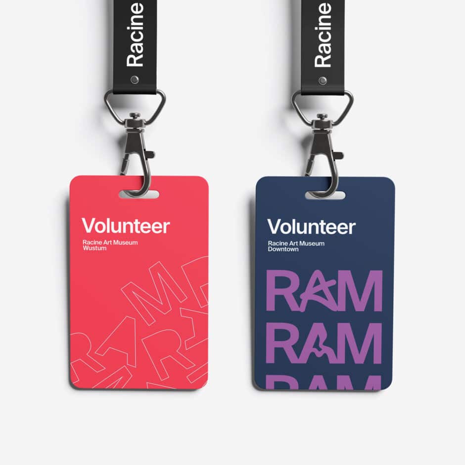 Two clipped volunteer badges hang side by side: a red Racine Art Museum West badge and navy RAM Downtown badge, with bold typography.